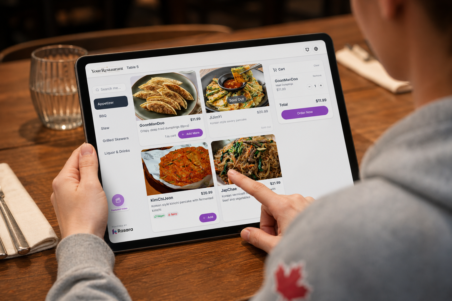 A guest choosing dishes on a tablet menu